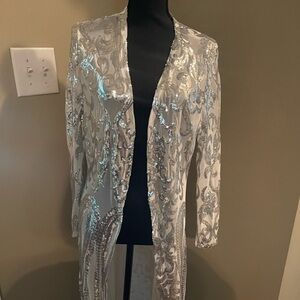 White, mesh net material.  Silver embellishments duster.